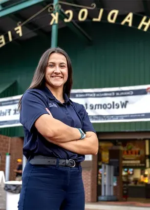  UNE student Morgan White standing in front Hadlock Field for a business internship with Seadogs